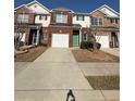Charming townhome featuring a brick facade, attached garage and a well-maintained lawn at 91 Brookway Trce, Norcross, GA 30071