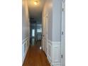 Hallway with wood floors and paneled walls, leading to other rooms at 91 Brookway Trce, Norcross, GA 30071