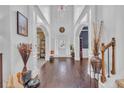 Grand two-story foyer with hardwood floors, arched entryways, and elegant architectural details at 115 Bellemeade Ct, Fayetteville, GA 30215