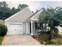 Charming one-story home with a one-car garage, inviting porch, and manicured landscaping at 1488 Cottage Way #32, Marietta, GA 30066