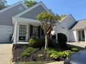 Charming home with a well-manicured front yard, covered porch, and inviting curb appeal at 1488 Cottage Way #32, Marietta, GA 30066