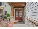 Welcoming entryway with double doors, brick accents, and covered porch at 5143 Micaela Way, Duluth, GA 30096