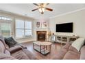 Cozy living room with fireplace, plush seating, and large TV at 5143 Micaela Way, Duluth, GA 30096