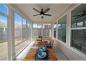 Cozy sunroom with comfortable seating and a ceiling fan at 518 Newstead Way, Woodstock, GA 30188