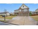 Beautiful two-story home featuring stone accents, a spacious front yard, and a double garage at 606 Discovery Ct, Acworth, GA 30102