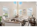 Bright and airy living room featuring high ceilings, large windows, and neutral décor at 606 Discovery Ct, Acworth, GA 30102