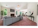 Bright living room featuring a fireplace, large windows, and an open floor plan at 6445 Marsham Dr, Atlanta, GA 30349