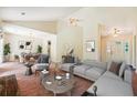 Cozy living room with vaulted ceilings, carpeted floors, and an open view to the dining area at 6445 Marsham Dr, Atlanta, GA 30349