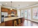 Well-lit kitchen with stainless steel appliances, granite countertops, and an island with barstool seating at 9942 Ashton Old Rd, Douglasville, GA 30135