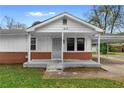 Cozy home with a quaint front porch and brick accents at 126 Washington St, Mcdonough, GA 30253