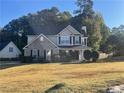 Inviting two-story home featuring a brick and siding exterior with a lush front lawn at 2013 Reserve Pkwy, Mcdonough, GA 30253