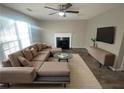 Modern living room with a large sectional sofa, fireplace, and a wall-mounted television at 2013 Reserve Pkwy, Mcdonough, GA 30253