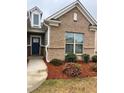 Inviting front entrance featuring a brick facade, manicured landscaping, and a stylish blue front door at 2660 Bateman Sw St, Powder Springs, GA 30127