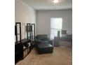 Cozy home office with a comfortable black chair, desk, and shelving for organized workspace at 2660 Bateman Sw St, Powder Springs, GA 30127