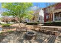 Community outdoor fire pit surrounded by benches and lush landscaping at 3180 Ashton Old Rd, Douglasville, GA 30135