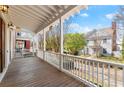 Relaxing front porch with wood flooring overlooking the landscaped front yard at 3180 Ashton Old Rd, Douglasville, GA 30135