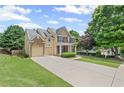 Beautiful two-story house with a long drive, attached garage, and lush green lawn at 6597 River Island Dr, Buford, GA 30518
