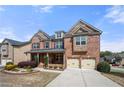 Lovely brick home with a charming front porch, landscaped yard, and a convenient two-car garage at 3750 Lake Haven Way, Atlanta, GA 30349