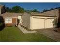 Charming home featuring a two-car garage, brick accents, and a well-maintained lawn at 4631 Calumet Cir, Duluth, GA 30096