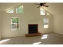 Bright living room with vaulted ceilings, a cozy fireplace, and ample natural light from large windows at 4631 Calumet Cir, Duluth, GA 30096