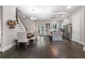 Open concept living space with a dining table and view of the bright, modern kitchen at 482 Pearl Cove Ct, Atlanta, GA 30350