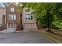 Beautiful exterior elevation of a brick townhome with a private garage at 482 Pearl Cove Ct, Atlanta, GA 30350