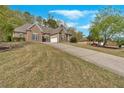 Inviting brick home with well-manicured lawn and concrete driveway at 4162 Crowder Nw Dr, Kennesaw, GA 30152