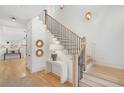 Bright foyer with wooden floors, staircase with black railings, console table and decorative round wall mirrors at 1299 Sunland Ne Dr, Brookhaven, GA 30319
