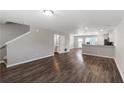 Open-concept living room with hardwood floors seamlessly connects to the kitchen and dining area at 310 Ashigan St, Union City, GA 30291