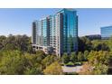 Striking high rise apartment building set among lush green trees during daylight at 3300 Windy Ridge Se Pkwy # 1309, Atlanta, GA 30339