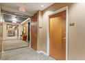 Condominium hallway featuring neutral carpeting and wood doors numbered 1309 at 3300 Windy Ridge Se Pkwy # 1309, Atlanta, GA 30339