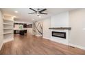 Open floor plan with living room, modern fireplace, and kitchen with island at 1972 Cambridge Ave, Atlanta, GA 30337