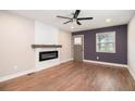 Living room with hardwood floors, modern fireplace, and ample natural light from the window at 1972 Cambridge Ave, Atlanta, GA 30337