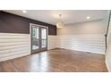 Living room featuring hardwood floors and stylish French doors leading to outdoor patio at 1972 Cambridge Ave, Atlanta, GA 30337