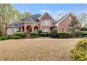 Beautiful brick home with lush green landscaping and a well-manicured lawn at 4231 Carrington Ct, Douglasville, GA 30135