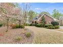 Well-maintained brick home with a curved driveway and mature landscaping at 4231 Carrington Ct, Douglasville, GA 30135
