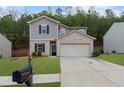 Charming two-story home featuring a brick facade, a well-manicured lawn, and an attached two-car garage at 6407 Barker Station Walk, Sugar Hill, GA 30518