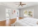 Bright main bedroom with hardwood floors, a ceiling fan, and large windows offering plenty of natural light at 1611 Flat Shoals Rd, Atlanta, GA 30316