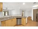 Open kitchen with stainless steel dishwasher, granite countertops, and hardwood floors at 390 17Th Nw St # 4048, Atlanta, GA 30363