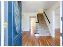 Inviting foyer with hardwood floors and decorative glass front door at 430 Holly Stream Trl, Roswell, GA 30075