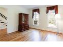 Bright room with hardwood floors, two windows, and traditional furniture at 430 Holly Stream Trl, Roswell, GA 30075