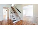 Spacious foyer with hardwood floors and a carpeted staircase at 430 Holly Stream Trl, Roswell, GA 30075
