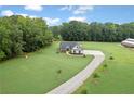 An aerial view of a lovely one-story home with a long driveway surrounded by trees at 340 Taylor Path, Dallas, GA 30157
