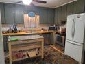 Functional kitchen with stainless steel appliances, ample cabinet space, and a movable island at 3905 Hunters Chase, Conyers, GA 30094