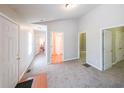Spacious hallway featuring neutral carpeting, white walls, and multiple doorways leading to various rooms in the home at 837 Forrest Se Cir, Atlanta, GA 30354