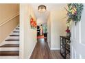 Inviting hallway featuring wood floors, elegant lighting and staircase leading to the upper level at 1501 Eastern Sunrise Ln, Decatur, GA 30034