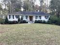 Attractive one-story home with dark shutters, mature landscaping and a welcoming front lawn at 4002 Wieuca Ne Rd, Atlanta, GA 30342