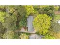 Aerial view of a home with mature trees providing ample shade and privacy at 5630 Lake Forrest Dr, Sandy Springs, GA 30342