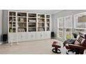 Spacious living room with custom built-in shelving and comfortable seating area at 1165 Lea Dr, Roswell, GA 30076