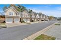 Street view featuring a row of charming townhomes with attached garages and well-maintained landscaping at 1929 Lake Heights Nw Cir # 2, Kennesaw, GA 30152